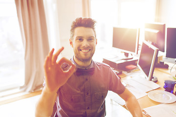 Image showing happy creative male office worker showing ok sign