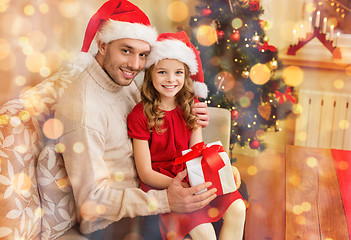 Image showing smiling father and daughter holding gift box