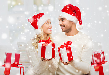 Image showing happy couple at home exchanging christmas gifts