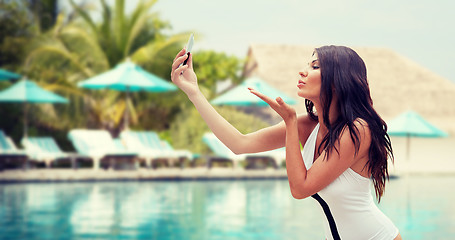 Image showing young woman taking selfie with smartphone