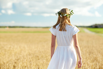 Image showing happy young woman in flower wreath on cereal field