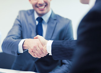 Image showing two businessmen shaking hands in office
