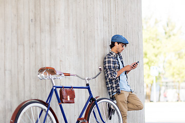 Image showing man with smartphone, earphones and bicycle