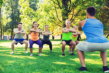 Image showing group of friends or sportsmen exercising outdoors