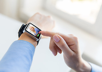 Image showing close up of hands with incoming call on smartwatch