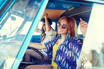 Image showing smiling young hippie women driving minivan car