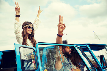 Image showing hippie friends over minivan car showing peace sign