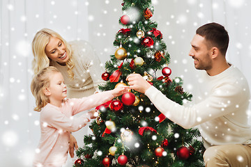 Image showing happy family decorating christmas tree at home