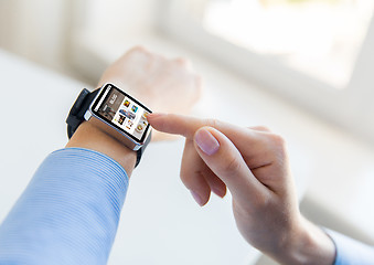 Image showing close up of hands with blog on smart watch screen