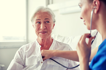 Image showing nurse with stethoscope and senior woman at clinic