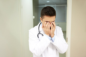 Image showing sad or crying male doctor at hospital ward