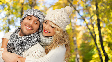 Image showing happy couple in warm clothes over autumn