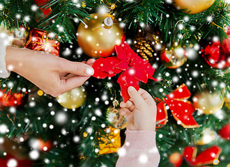 Image showing close up of family decorating christmas tree