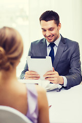 Image showing smiling man looking at menu on tablet pc computer