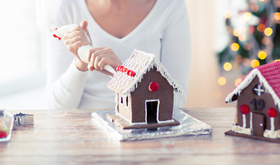 Image showing close up of woman making gingerbread houses