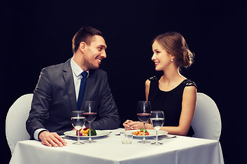 Image showing smiling couple eating main course at restaurant