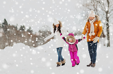 Image showing happy family in winter clothes walking outdoors