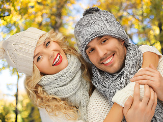 Image showing happy couple in warm clothes over autumn