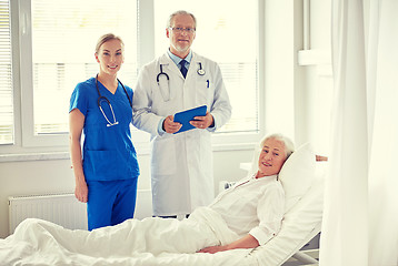 Image showing doctor and nurse visiting senior woman at hospital