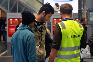 Image showing Striking Norwegian train driver assisting travelers