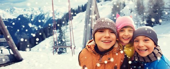 Image showing happy children hugging over winter background