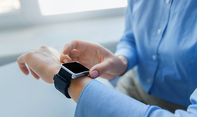 Image showing close up of female hands setting smart watch