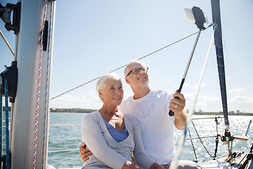 Image showing senior couple taking selfie on sail boat or yacht