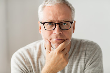 Image showing close up of senior man in glasses thinking