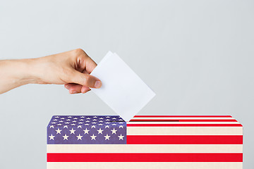 Image showing man putting his vote into ballot box on election