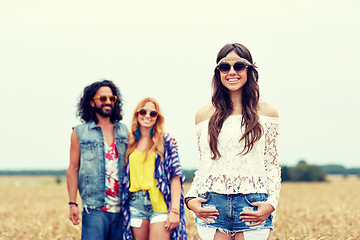 Image showing smiling young hippie friends on cereal field