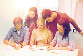 Image showing smiling students with notebooks at school