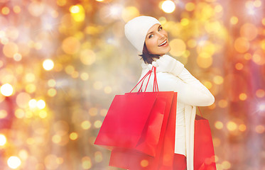 Image showing happy woman in winter clothes with shopping bags