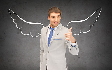 Image showing businessman with angel wings showing thumbs up