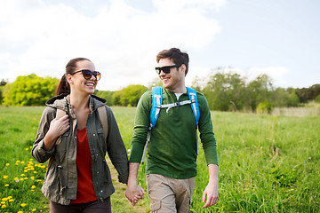 Image showing happy couple with backpacks hiking outdoors