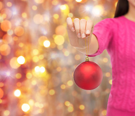 Image showing close up of woman in sweater with christmas ball