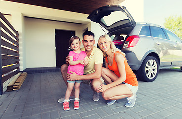 Image showing happy family with hatchback car at home parking