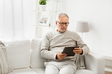 Image showing senior man with tablet pc at home