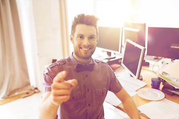 Image showing happy male office worker pointing finger at you