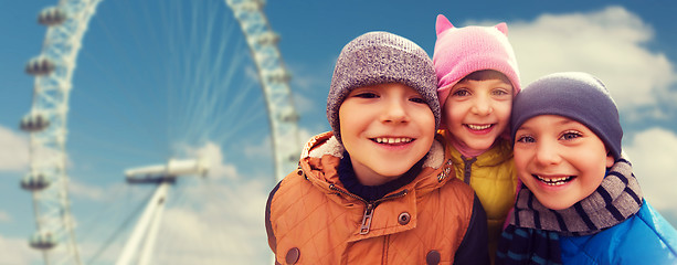 Image showing happy little children faces over ferry wheel