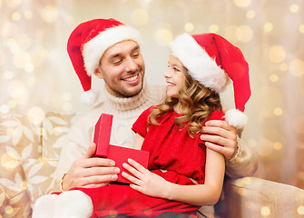 Image showing smiling father and daughter opening gift box