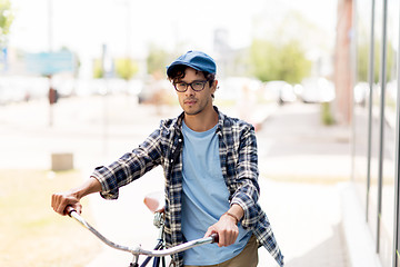 Image showing young man with fixed gear bicycle walking in city