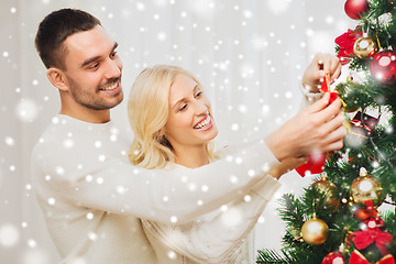 Image showing happy couple decorating christmas tree at home