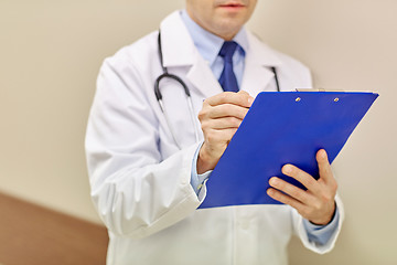 Image showing close up of doctor with clipboard at hospital