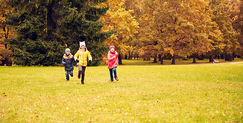 Image showing group of happy little kids running outdoors