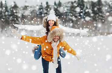 Image showing happy couple having fun over winter background