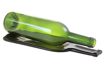 Image showing green glass bottle with one flat bottle