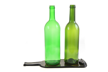 Image showing green glass bottles with one flat bottle