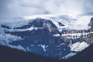 Image showing Snow on mountains with clouds