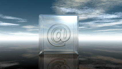 Image showing email symbol in glass cube under cloudy sky - 3d rendering