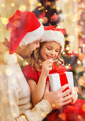 Image showing smiling father and daughter opening gift box